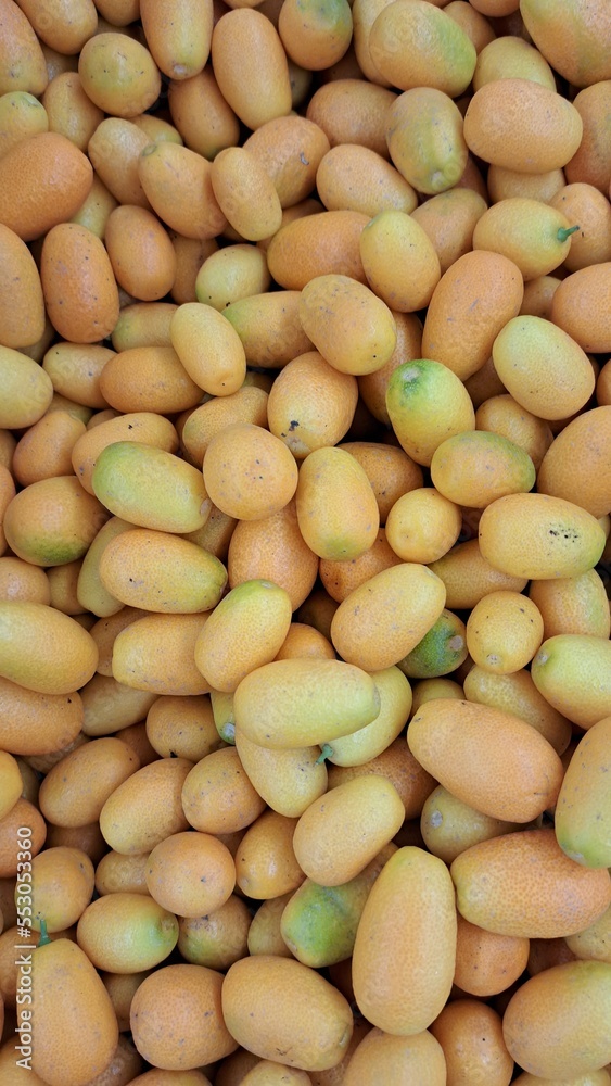 Ripe kumquat. Located throughout the frame. Top view. Background. Texture. Copy space Ripe kumquat. Located throughout the frame. Top view. Background. Texture. Copy space