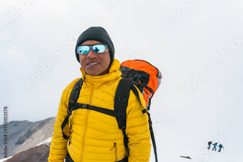 Man with backpack trekking in mountains