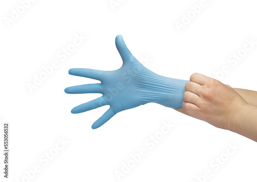  hand puts on blue disposable medical gloves isolated on white background. Infection control concept.