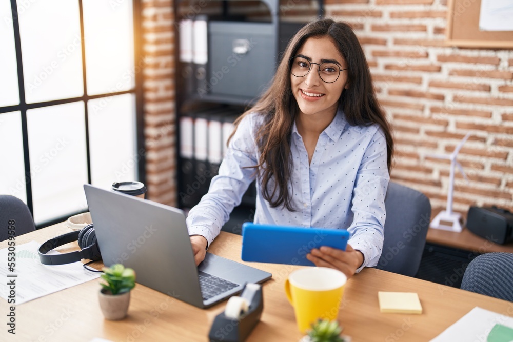 Young hispanic girl business worker using laptop working at office Young hispanic girl business worker using laptop working at office