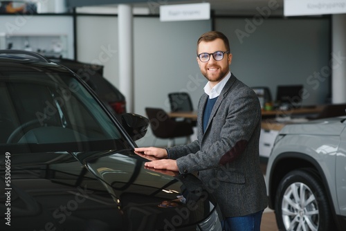 Man minded customer male buyer client in suit choose auto to go look aside want buy new automobile in car showroom vehicle salon dealership store motor show indoor Sales concept © Serhii
