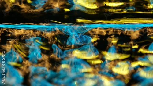 Awesome bg with magic particles float in liquid, light rays like laser show, light effects and bokeh, DOF. Glowing multi-colored particles circle underwater forming cloud. Luma matte as alpha channel.