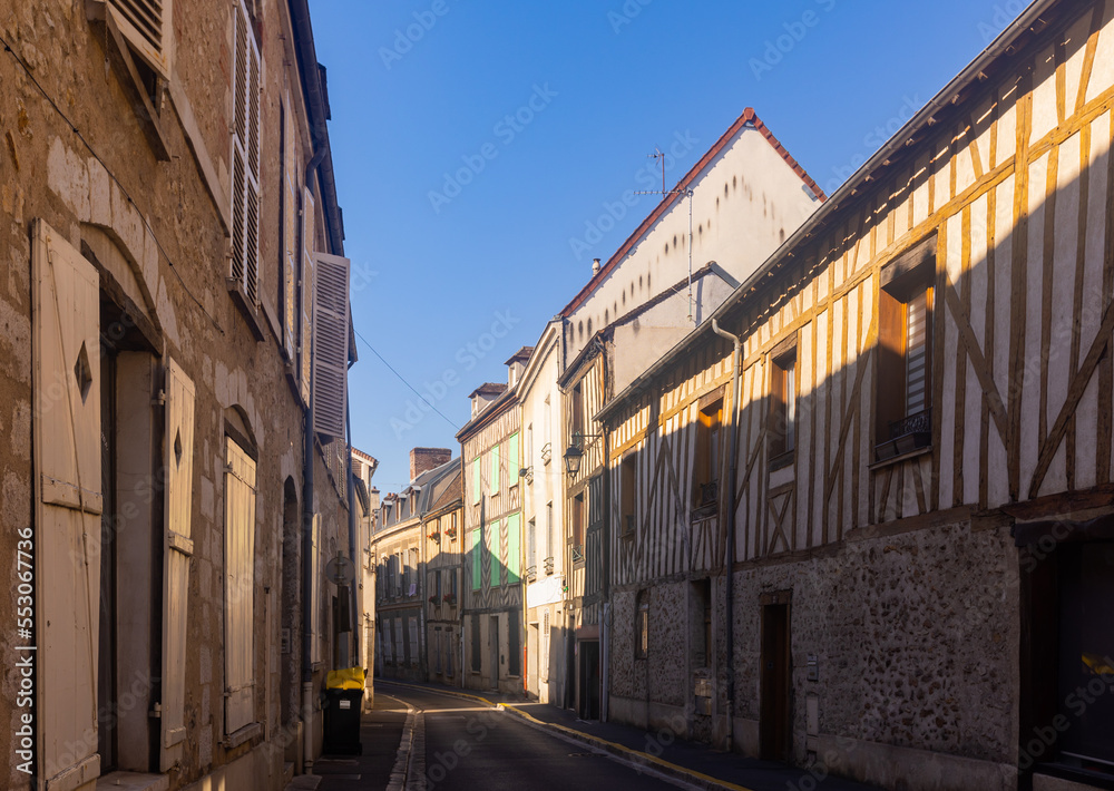 Traditional architecture of Provins. View of medieval half-timbered houses on narrow streets in small French town on summer day