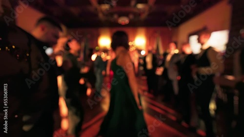 Blurry: People are dancing and partying at a Christmas event