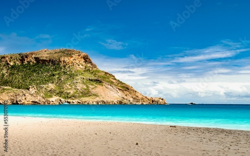White sand beach and rocky hill