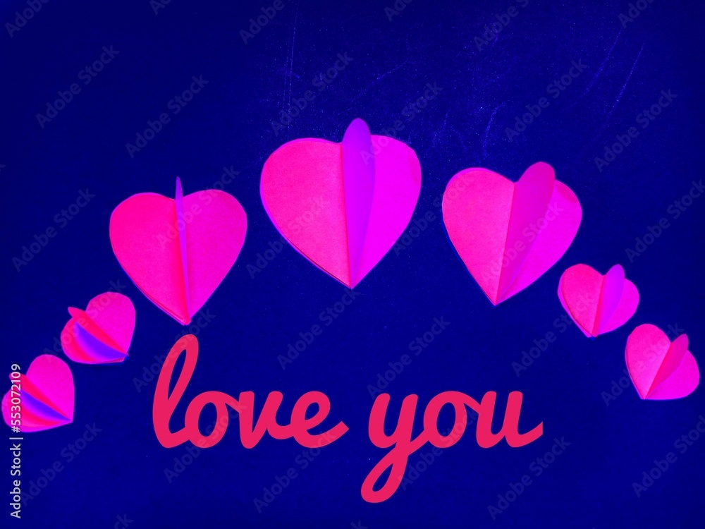 Pink hearts on blue background with The word 