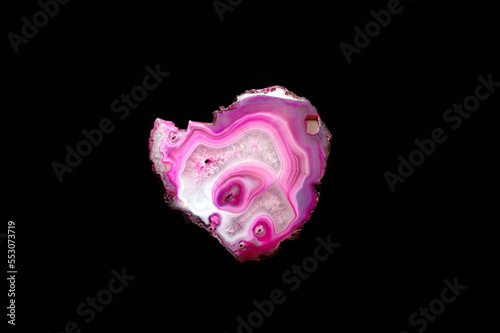 Pink agate macro detail black isolated background. close-up polished semi-precious gemstone copy space