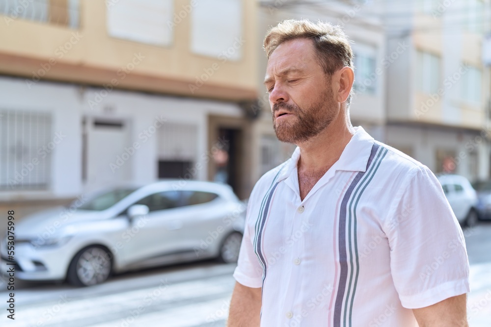 Middle age man with worried expression standing at street Middle age man with worried expression standing at street