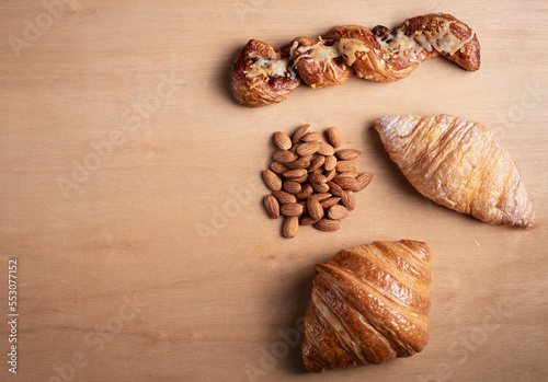 Topview shot of almonds with big slices of bread on dark wooden background concept of health care 