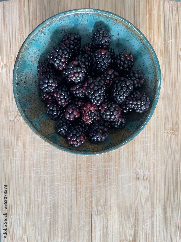 Organic Blackberries in ceramic bowl Organic Blackberries in ceramic bowl