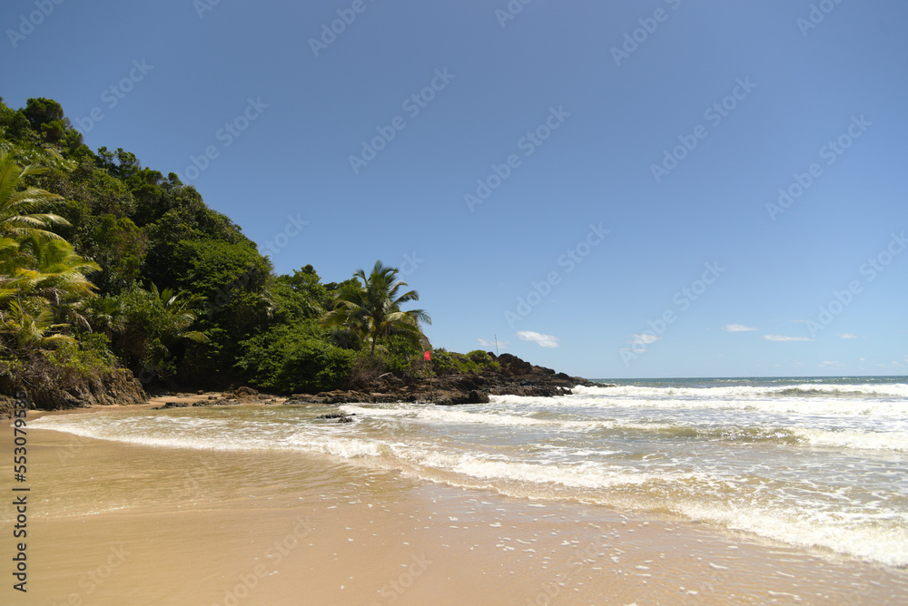 Beautiful panoramic view of a paradise beach in full light on a sunny day with blue sky and clear water
