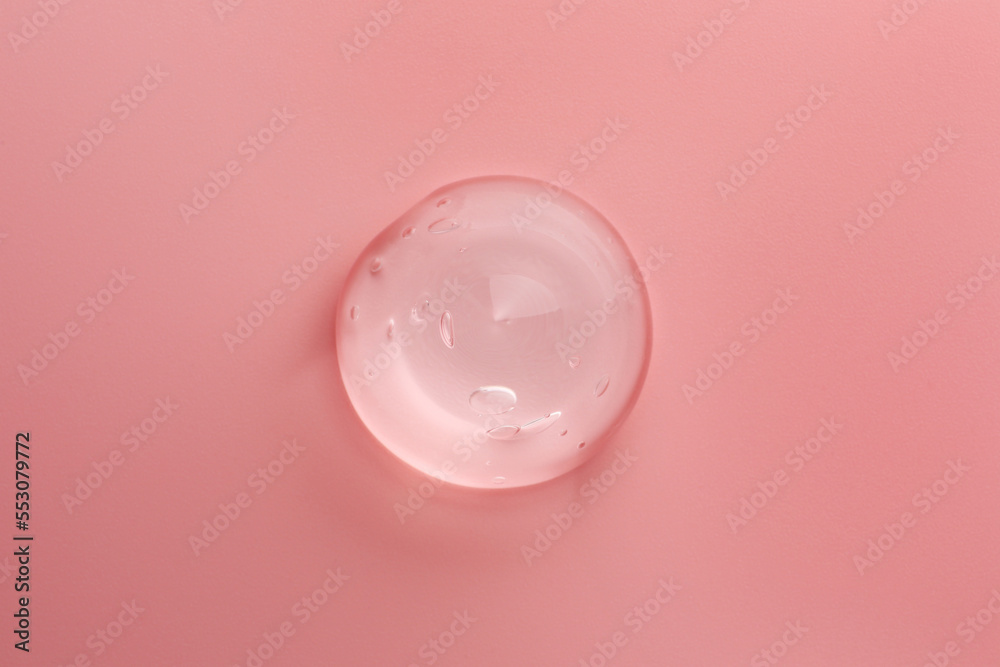 Sample of transparent gel on pink background, top view Sample of transparent gel on pink background, top view