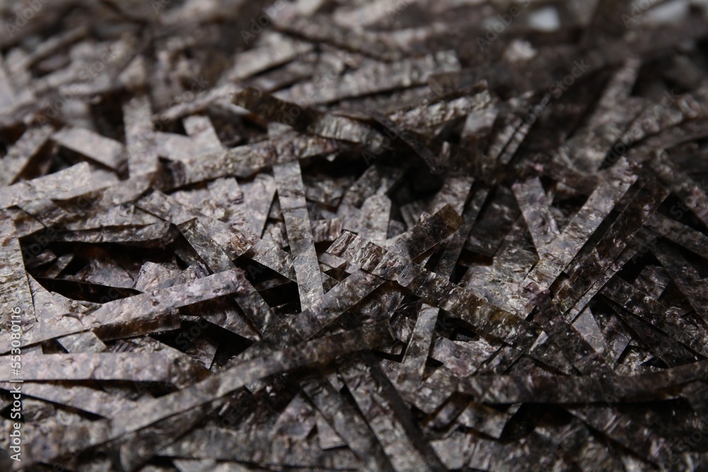 Fototapeta premium Chopped crispy nori sheets as background, closeup