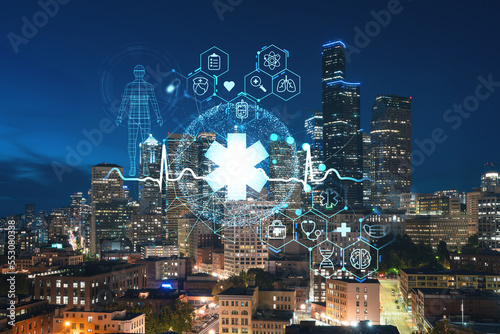 Fototapeta Naklejka Na Ścianę i Meble -  Illuminated aerial cityscape of Seattle, downtown at night time, Washington, USA. Health care digital medicine hologram. The concept of treatment and disease prevention