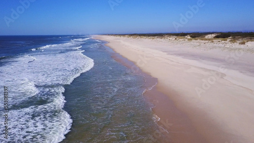 Low flying along sand beach shore