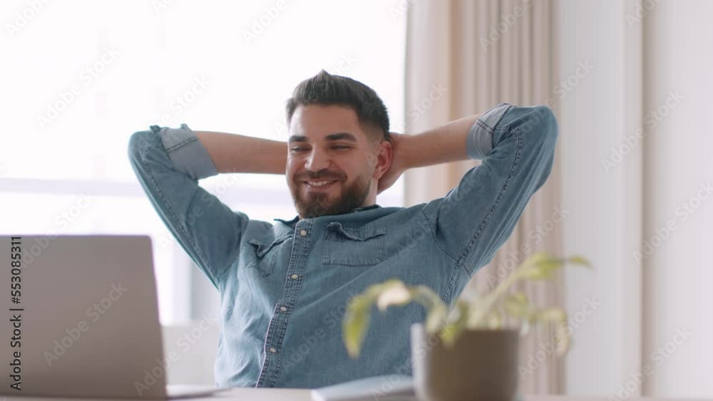 Young middle eastern man feeling satisfaction, looking at laptop screen with finished project, tracking shot, ree space Young middle eastern man feeling satisfaction, looking at laptop screen with finished project, tracking shot, ree space