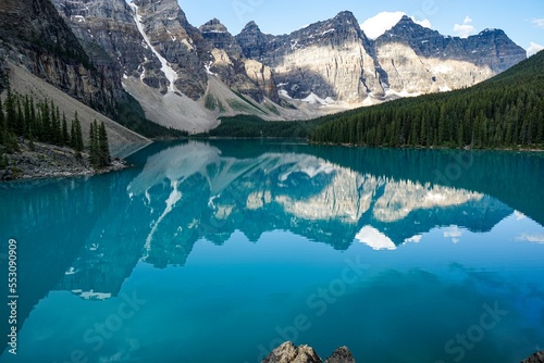 Moraine Lake is a stunningly beautiful lake located in Banff National Park, Alberta, Canada. The lake is known for its vibrant blue waters and the towering peaks of the Canadian Rockies.