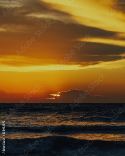 View of the golden sunset near the sea. © ellinnur