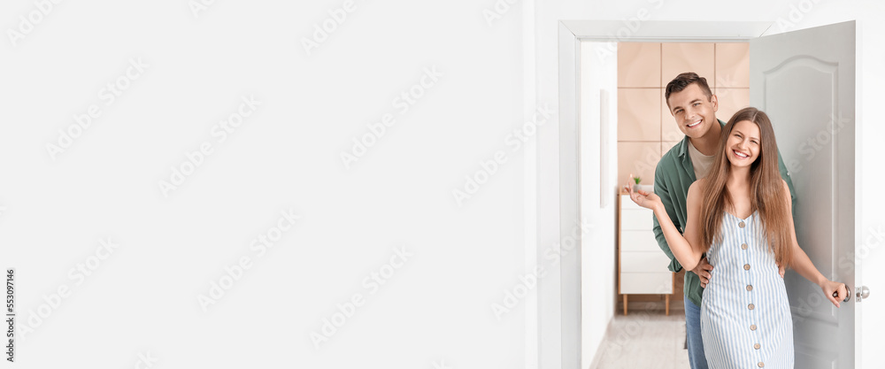 Happy couple inviting guest at their new home. Banner for design Happy couple inviting guest at their new home. Banner for design