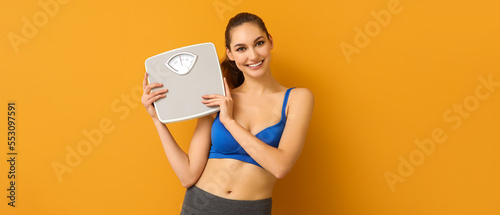 Slim young woman with scale...