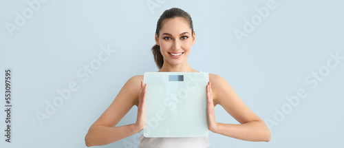 Young woman with scales on ...