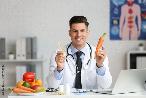 Male doctor with vitamins a...