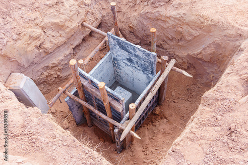 Concrete footings and reinforcing rod for building under construction.