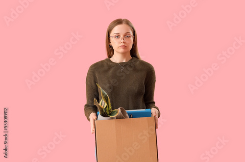 Fired young woman holding b...