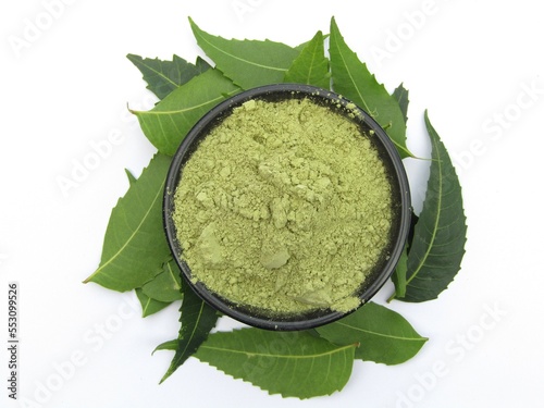 Neem leaves powder in a bowl isolated on white background 