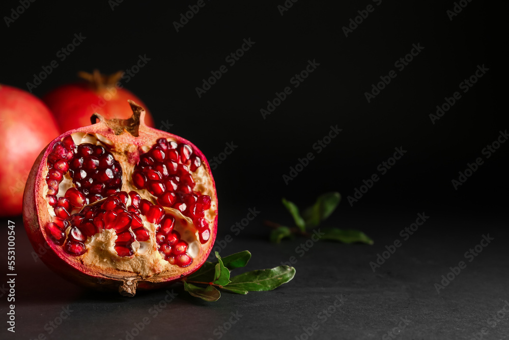 Half of fresh pomegranate on dark background Half of fresh pomegranate on dark background