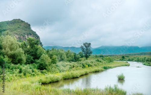 Landscape with mountains, trees and a river © xy