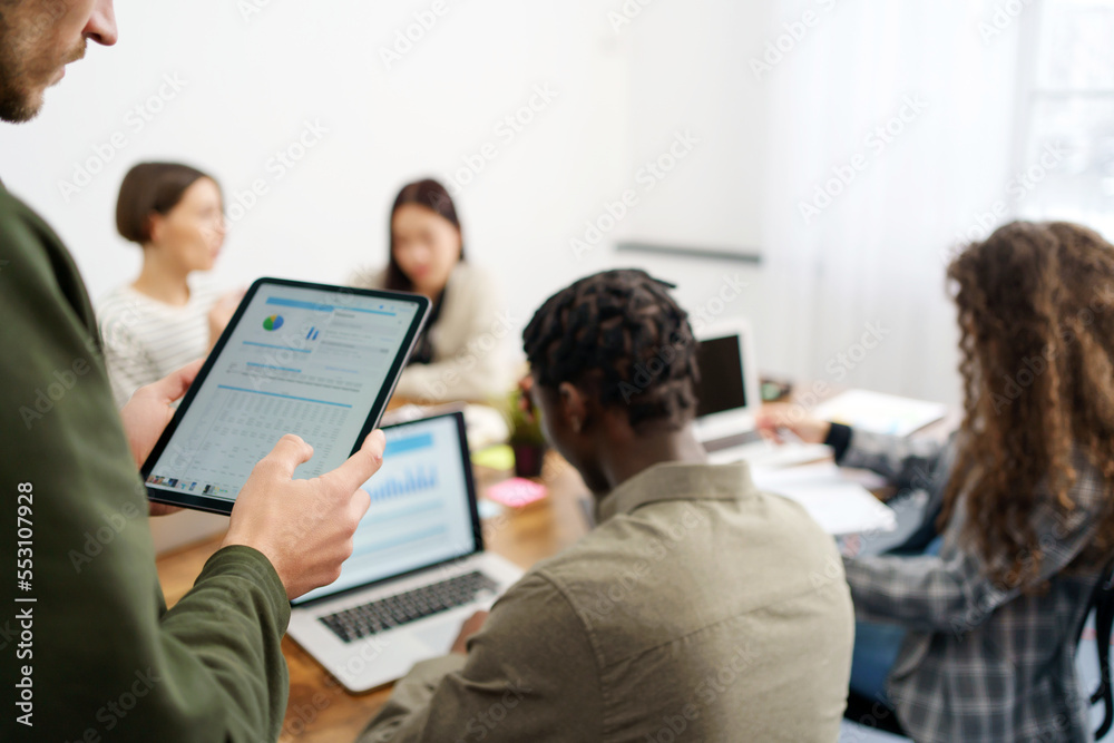 business person uses a tablet to check financial data. Graph research