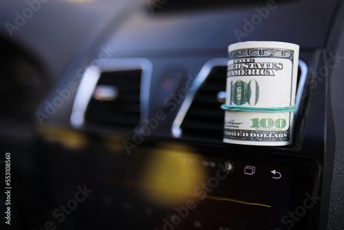 dollars with a car key lie in inside cars. financial concept