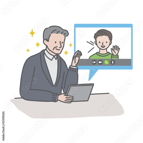 タブレットを使って孫とビデオ通話をするシニア男性