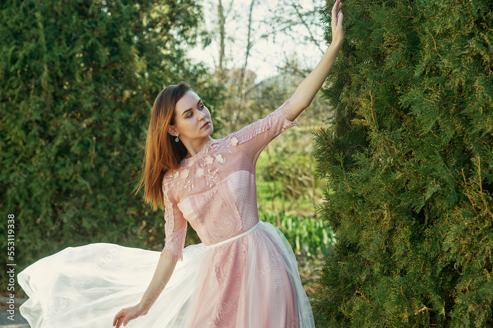 Young attractive woman in a beautiful dress outdoors