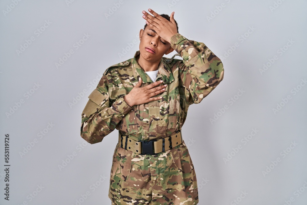 Beautiful african american woman wearing camouflage army uniform touching forehead for illness and fever, flu and cold, virus sick