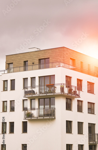 Sunset in a European middle house apartment. Concept of modern architecture for a better living. Contemporary medium-sized flat building in Europe