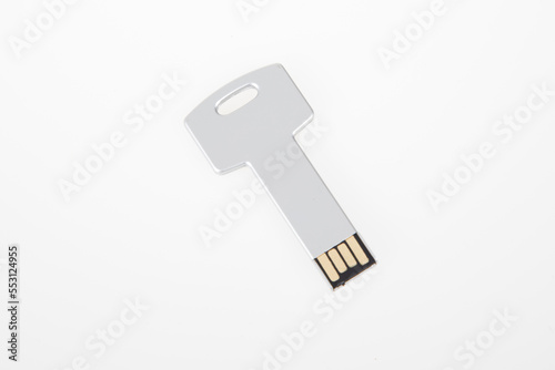 metal silver grey USB key in the shape of a metal USB flash drive on white background