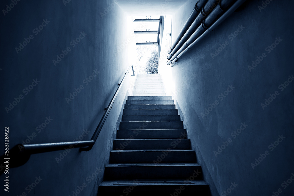 Fototapeta premium Bright light shining at the end of the staircase