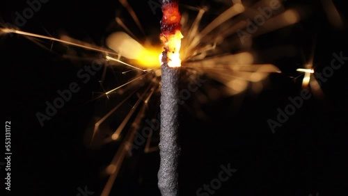 Lightening sparkler or Bengal lights close-up macro on a black background. The concept of the holiday of the new year, birthday