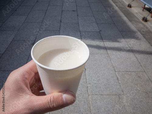 holding a cup of japanese traditional drink 