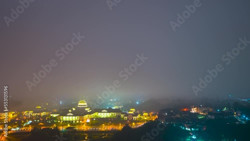 4K Time lapse of National Palace, Monarch of Malaysia overlooking the four skyscrapper tower during low cloud night	 photo