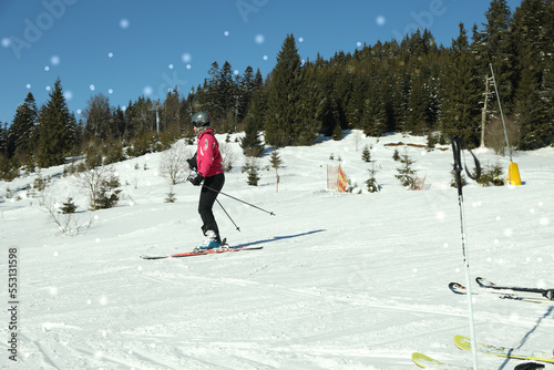 Skier on ski slope in sunny day
