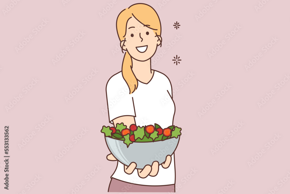 Smiling woman hold bowl of vegetarian salad Smiling woman hold bowl of vegetarian salad