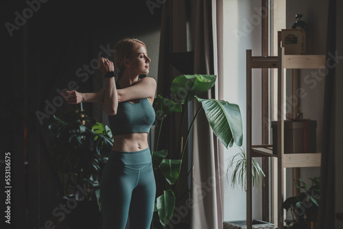 Woman warming up before working out at home