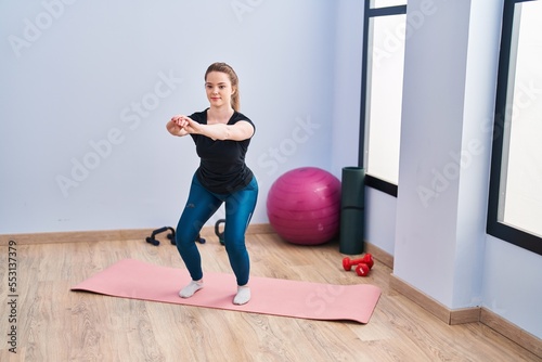Young blonde woman smiling confident training at sport center