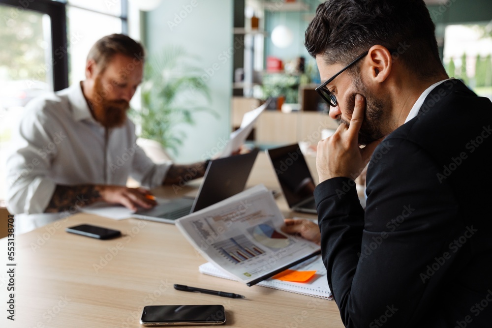 Group of multiethnic businesspeople working together in office Group of multiethnic businesspeople working together in office