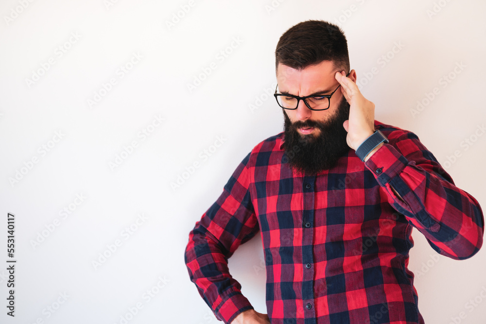 Portrait of man who is tired and having headache. Portrait of man who is tired and having headache.