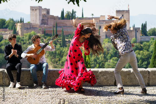 Musician and dancers performing flamenco at Alhambra, Granada, Spain photo