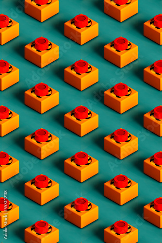 Three dimensional pattern of rows of push buttons flat laid against green background